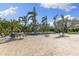Backyard pool with a spacious patio area, lush landscaping, and seating area at 450 Bayshore Dr, Terra Ceia, FL 34250