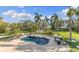 Stunning backyard pool with brick patio, overlooking lush tropical foliage and peaceful waterfront at 450 Bayshore Dr, Terra Ceia, FL 34250