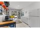 Organized utility room with lots of storage, refrigerator, and direct pool access at 450 Bayshore Dr, Terra Ceia, FL 34250