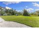Large lot with grass, an outbuilding, and surrounding mature trees offers room to roam at 450 Bayshore Dr, Terra Ceia, FL 34250