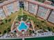 Aerial view of a luxurious condo complex with a beautiful pool area surrounded by lush landscaping at 4900 Brittany S Dr # 1706, St Petersburg, FL 33715
