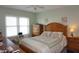 Bedroom with a comfortable bed, wooden furniture, and bright window light at 4900 Brittany S Dr # 1706, St Petersburg, FL 33715
