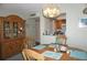 Bright dining area with wooden furniture, stylish lighting, and an open view into the well-equipped kitchen at 4900 Brittany S Dr # 1706, St Petersburg, FL 33715