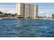 An expansive waterfront view of a high rise condo building with views of the water, docks, and tropical landscaping at 4900 Brittany S Dr # 1706, St Petersburg, FL 33715