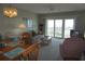 Inviting living room with plush seating, and large sliding doors that open to a balcony with scenic waterfront views at 4900 Brittany S Dr # 1706, St Petersburg, FL 33715