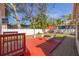 View of backyard with brick patio, wooden deck, landscaping, and lounge chairs at 505 27Th N Ave, St Petersburg, FL 33704