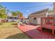 Backyard showcasing a red wooden deck, lounge chairs, and a partially covered patio with grill at 505 27Th N Ave, St Petersburg, FL 33704