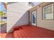 View of red wooden deck and exterior door of home at 505 27Th N Ave, St Petersburg, FL 33704