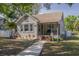 Charming bungalow with inviting front porch, mature landscaping, and a welcoming walkway at 505 27Th N Ave, St Petersburg, FL 33704