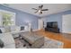 Cozy living room featuring hardwood floors, a ceiling fan, and ample natural light at 505 27Th N Ave, St Petersburg, FL 33704