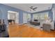 Bright living room featuring hardwood floors, a comfortable seating area, and seamless access to dining room at 505 27Th N Ave, St Petersburg, FL 33704