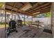 Covered patio with grill and picnic table in a fenced backyard, ideal for outdoor entertaining at 505 27Th N Ave, St Petersburg, FL 33704