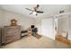 Inviting bedroom featuring a ceiling fan, closet, wooden desk, and comfortable setup for relaxation at 5080 Locust Ne St # 321, St Petersburg, FL 33703