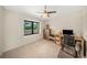 Bright bedroom with a ceiling fan and a cozy workspace next to a window overlooking lush greenery at 5080 Locust Ne St # 321, St Petersburg, FL 33703
