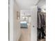 Bright bedroom featuring a ceiling fan, window, blue bedspread, and a well-organized closet with louvered doors at 5080 Locust Ne St # 321, St Petersburg, FL 33703