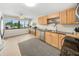 Well-lit kitchen with wood cabinets, stainless steel appliances, and a large window that offers natural light and neighborhood views at 5080 Locust Ne St # 321, St Petersburg, FL 33703