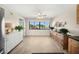 Bright kitchen area with sleek cabinets, stainless steel refrigerator, and views of community amenities through a large window at 5080 Locust Ne St # 321, St Petersburg, FL 33703