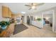 Modern kitchen with stainless steel appliances, wood cabinets, and a breakfast bar, adjacent to the dining area and living room at 5080 Locust Ne St # 321, St Petersburg, FL 33703