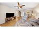 Bright living room featuring a ceiling fan, a TV and view of the adjacent dining area at 5080 Locust Ne St # 321, St Petersburg, FL 33703