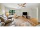Bright living room with comfortable seating, ceiling fan, and hardwood floors, creating a relaxing atmosphere at 5080 Locust Ne St # 321, St Petersburg, FL 33703