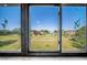 Community amenities view from a window featuring a pool, clubhouse, and manicured green spaces on a beautiful day at 5080 Locust Ne St # 321, St Petersburg, FL 33703
