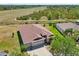 Aerial view of a well-maintained home with a three-car garage and lush landscaping at 627 Washita Stone Dr, Ruskin, FL 33570