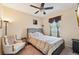 Cozy bedroom with a comfortable bed, ceiling fan, and natural light from the window at 627 Washita Stone Dr, Ruskin, FL 33570