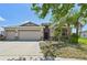 Charming single-story home featuring a well-manicured lawn, a three-car garage, and inviting curb appeal at 627 Washita Stone Dr, Ruskin, FL 33570