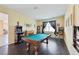 Spacious game room featuring a billiards table, arcade game, and fireplace, perfect for entertainment at 627 Washita Stone Dr, Ruskin, FL 33570