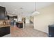 Open-concept kitchen with dark cabinets, granite countertops, stainless steel appliances, and an island with a sink at 627 Washita Stone Dr, Ruskin, FL 33570