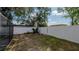 A spacious backyard features a pristine white fence and verdant trees at 6414 Larmon St, Tampa, FL 33634