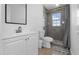 Modern bathroom featuring a new vanity with mirror and a tiled glass-enclosed shower with a window at 6414 Larmon St, Tampa, FL 33634