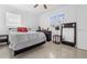 Well-lit bedroom with ceramic tile flooring, modern furnishings, and double-paned window at 6414 Larmon St, Tampa, FL 33634