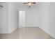 Well-lit empty bedroom with a ceiling fan and large closet with paneled sliding door at 6414 Larmon St, Tampa, FL 33634