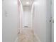 Bright hallway with tile floors and a closet; offers seamless passage between rooms at 6414 Larmon St, Tampa, FL 33634
