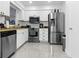 Modern kitchen featuring stainless steel appliances, white cabinets, and lots of counter space at 6414 Larmon St, Tampa, FL 33634