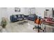Modern living room with shiny tile flooring, light walls, sleek furniture, and great access to kitchen at 6414 Larmon St, Tampa, FL 33634