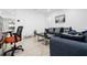 Bright living room boasts shiny tile flooring, modern furniture and decor at 6414 Larmon St, Tampa, FL 33634