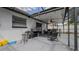 Patio area including a grill, dining area, ceiling fan and lights, all within a screened enclosure at 6414 Larmon St, Tampa, FL 33634