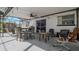 Covered patio area featuring outdoor seating, a ceiling fan and light, and a sliding glass door to the interior at 6414 Larmon St, Tampa, FL 33634