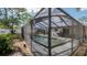 A screened-in pool offers relaxation and recreation in a private backyard setting at 6414 Larmon St, Tampa, FL 33634
