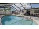 Large screened-in pool area featuring a lounge area, outdoor dining space and a fenced yard at 6414 Larmon St, Tampa, FL 33634