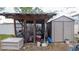 Outdoor shed with miscellaneous items stored inside and outside the screened-in enclosure at 6414 Larmon St, Tampa, FL 33634
