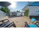 Inviting backyard featuring a brick patio, lounge chairs, and covered seating area, perfect for outdoor relaxation at 7006 N Duncan Ave, Tampa, FL 33604