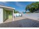 Brick-paved backyard provides lounging and dining spaces for easy outdoor lifestyle at 7006 N Duncan Ave, Tampa, FL 33604