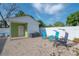 Relaxing backyard featuring paved patio, comfortable lounge chairs, and a charming house exterior at 7006 N Duncan Ave, Tampa, FL 33604