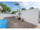 Backyard showing brick pavers, plants, and a long white fence at 7006 N Duncan Ave, Tampa, FL 33604