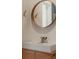 Bathroom sink with a rectangle bowl, a modern faucet, and a round mirror at 7006 N Duncan Ave, Tampa, FL 33604