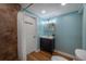 Inviting blue bathroom featuring tiled shower, modern vanity, and toilet, offering a cozy and updated space at 7006 N Duncan Ave, Tampa, FL 33604