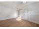 Sunlit bedroom with sliding barn door, laminate floors, and fresh paint at 7006 N Duncan Ave, Tampa, FL 33604